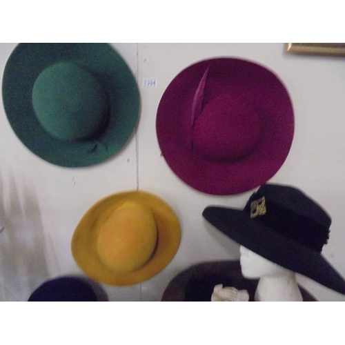 1394 - A good collection of vintage hats and hat boxes including bowler hat, straw boater etc.,