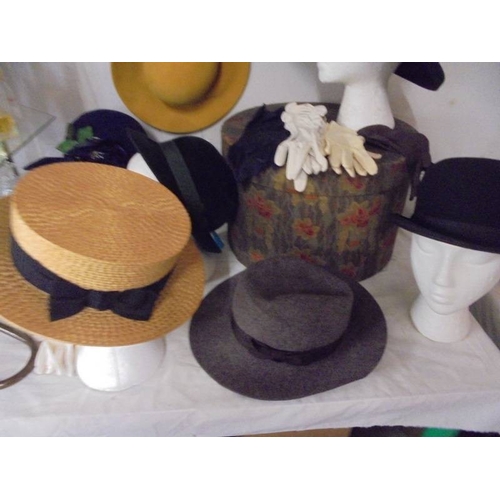 1394 - A good collection of vintage hats and hat boxes including bowler hat, straw boater etc.,