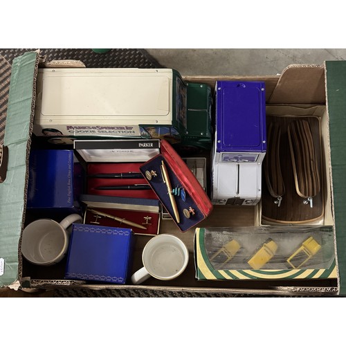 1396 - A box of miscellaneous including Parker pens, biscuit tins, Ringtons, Lledo van set etc.,