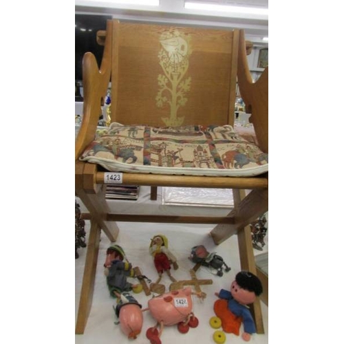 1423 - An Arts & crafts style oak chair with peg fittings.