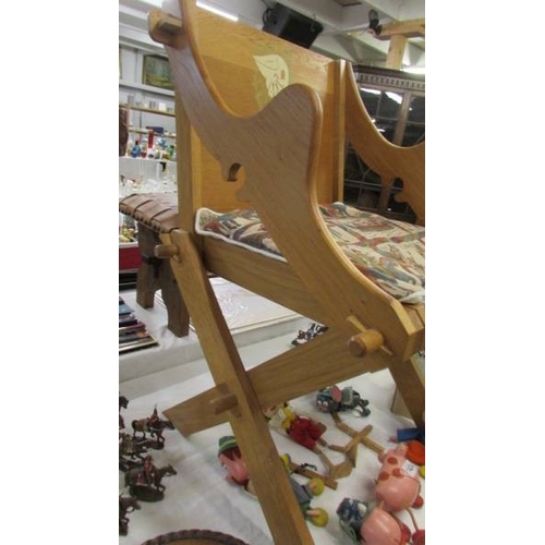 1423 - An Arts & crafts style oak chair with peg fittings.