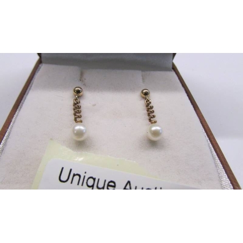 1071 - A pair of 9ct gold ear pendants with cultured pearl drops.