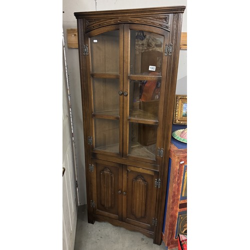 1382 - An oak cottage style corner cabinet with glazed doors.