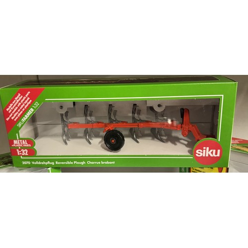 1452 - 7 boxed Siku agricultural vehicles Nos. 3652, 3653, 2070, 7070, 3470,02884 and 3095