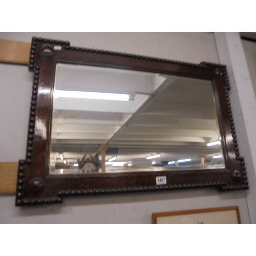 1467 - An oak framed bevel edged mirror.