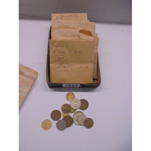 1242 - A quantity of foreign coins in envelopes.