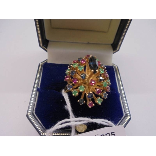 1100 - A 14k gold ring set coloured stones, size L, 7.89 grams