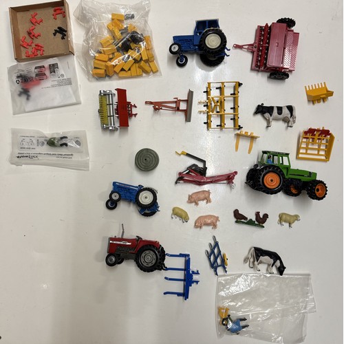 1461 - Four trays of unboxed Britains tractors, implements and farm animals etc.,