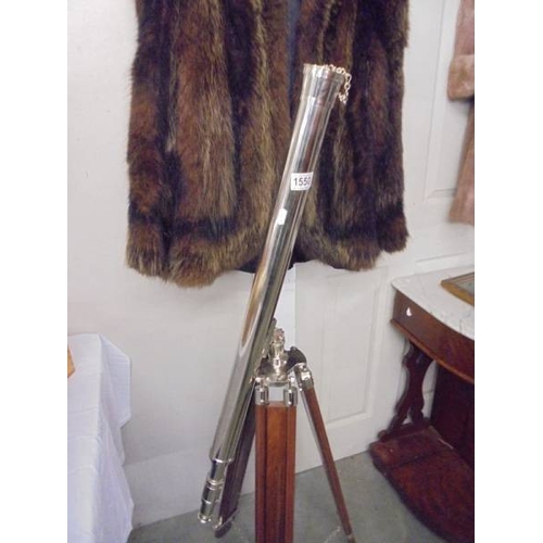 1550 - A large chrome plated telescope on a teak tripod base.