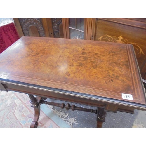 1558 - A Georgian inlaid walnut veneered fold over card table with beaded brass edging.