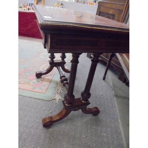 1558 - A Georgian inlaid walnut veneered fold over card table with beaded brass edging.