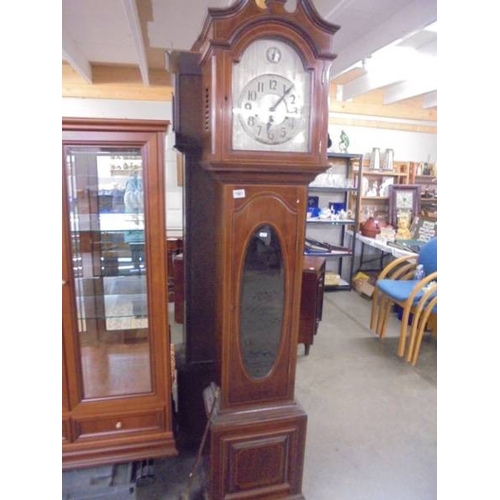 1561 - A mahogany inlaid long case clock with silvered dial and Westminster chime.