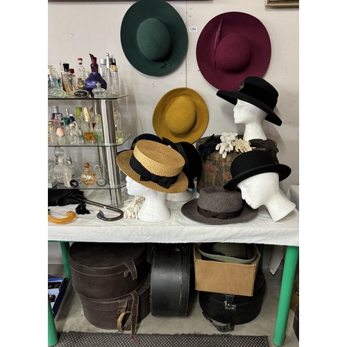 1394 - A good collection of vintage hats and hat boxes including bowler hat, straw boater etc.,