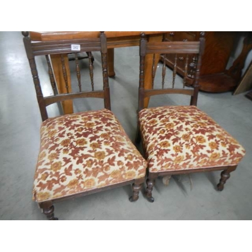 242 - A pair of mahogany nursing chairs.