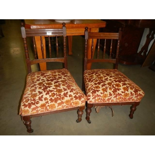 242 - A pair of mahogany nursing chairs.
