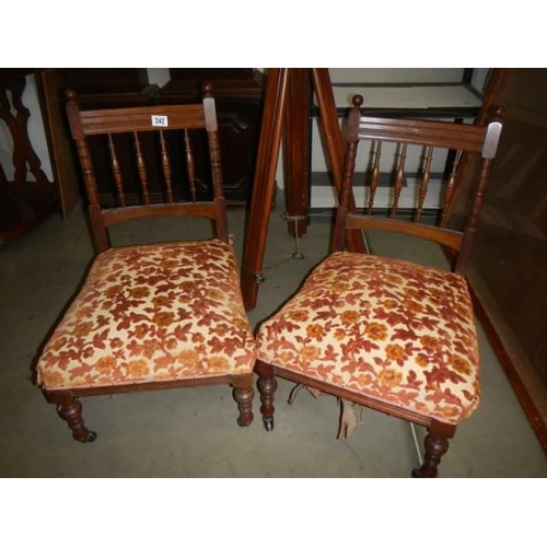 242 - A pair of mahogany nursing chairs.