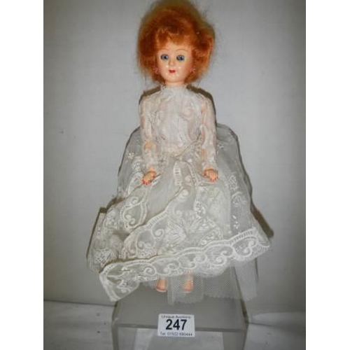 247 - A vintage doll in original dress.