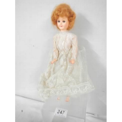 247 - A vintage doll in original dress.