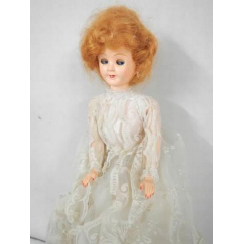 247 - A vintage doll in original dress.