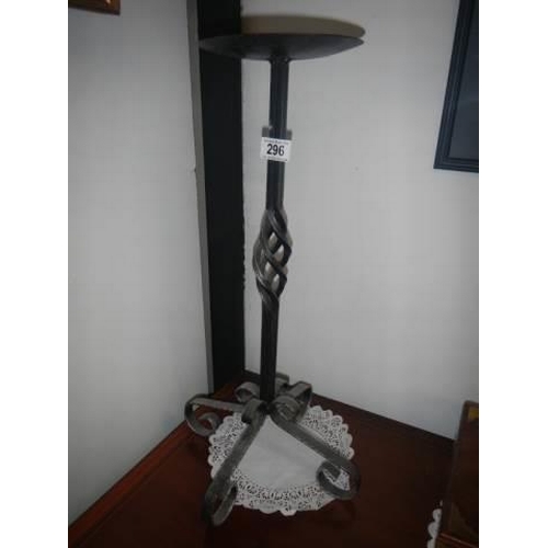 296 - A tall wrought iron candle holder.