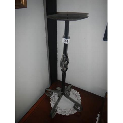 296 - A tall wrought iron candle holder.