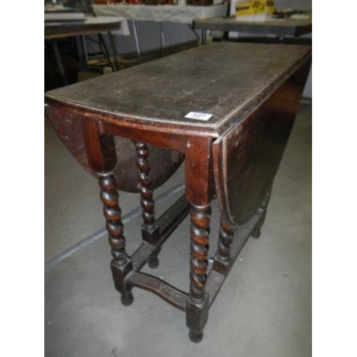 327 - An oak barley twist gate leg table.