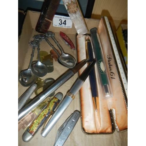 34 - A mixed lot including fountain pens, souvenir spoons etc.,