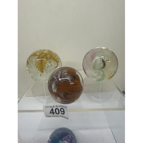 409 - 7 Caithness paperweights, all marked.