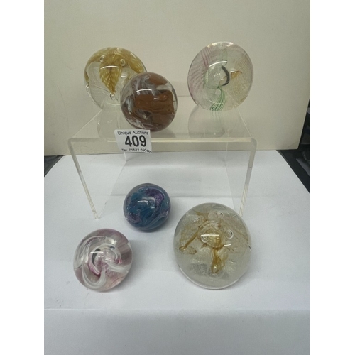 409 - 7 Caithness paperweights, all marked.