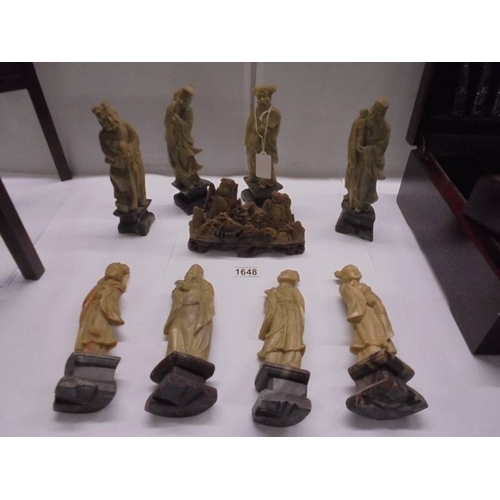 1648 - Eight circa 1900 carved soapstone Chinese figures and a carving of a mountain village.