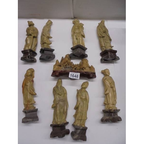 1648 - Eight circa 1900 carved soapstone Chinese figures and a carving of a mountain village.