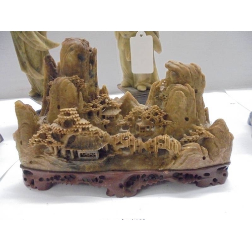 1648 - Eight circa 1900 carved soapstone Chinese figures and a carving of a mountain village.