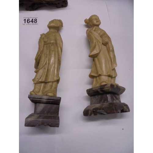 1648 - Eight circa 1900 carved soapstone Chinese figures and a carving of a mountain village.