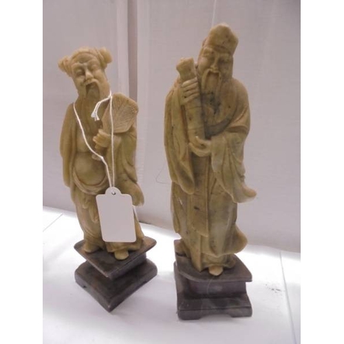 1648 - Eight circa 1900 carved soapstone Chinese figures and a carving of a mountain village.
