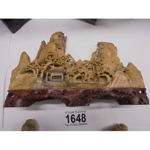 1648 - Eight circa 1900 carved soapstone Chinese figures and a carving of a mountain village.