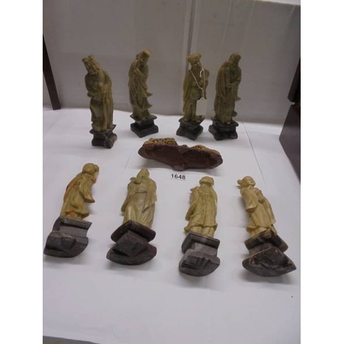1648 - Eight circa 1900 carved soapstone Chinese figures and a carving of a mountain village.