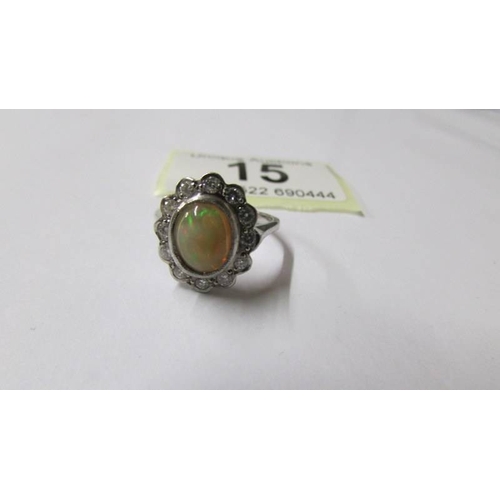 15 - An 18ct gold opal and diamond oval ring, size M, 6.6 grams.