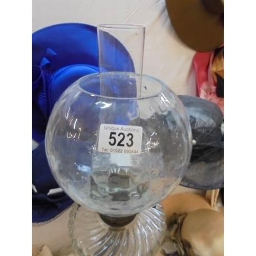 523 - An early 20th century oil lamp with shade.