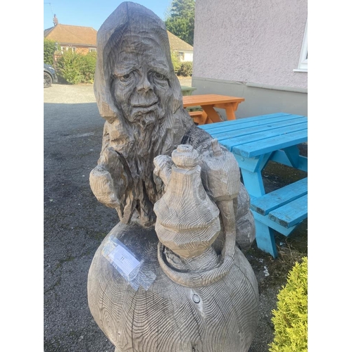 11 - A carved wooden figure of the Caterpillar from Alice in Wonderland. Height approximately 59 inches.