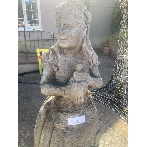 12 - A carved wooden figure of Alice from Alice in Wonderland. Approximately 60 inches high.
