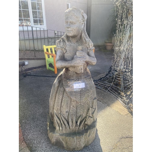 12 - A carved wooden figure of Alice from Alice in Wonderland. Approximately 60 inches high.