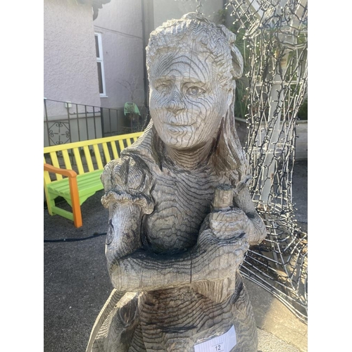 12 - A carved wooden figure of Alice from Alice in Wonderland. Approximately 60 inches high.