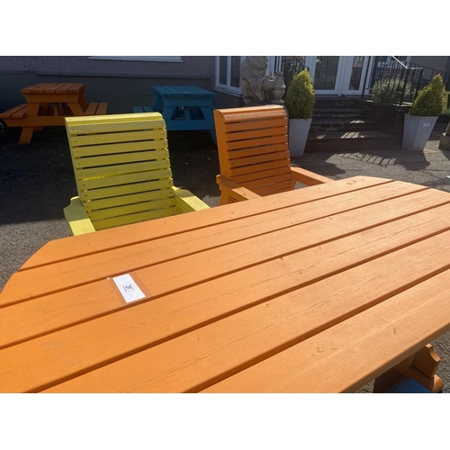 21 - A wooden garden table and four heavy wooden chairs. Painted different colours.