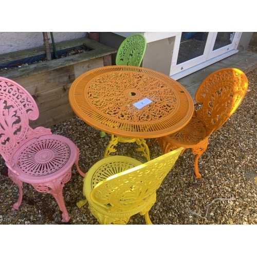 27 - A metal garden patio set, consisting of a table and four chairs in multicoloured paint.