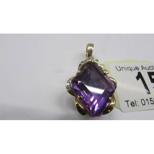 15 - A 14k gold pendant set large amethyst coloured stone, total weight 7.8 grams.