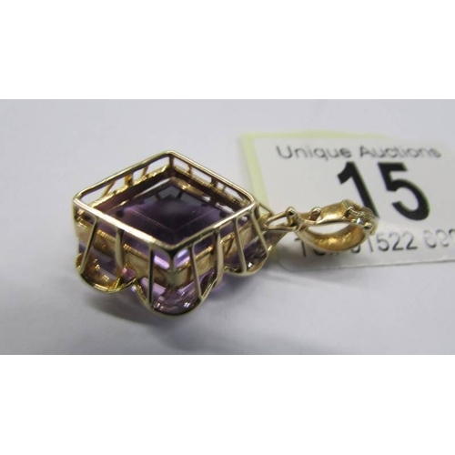 15 - A 14k gold pendant set large amethyst coloured stone, total weight 7.8 grams.