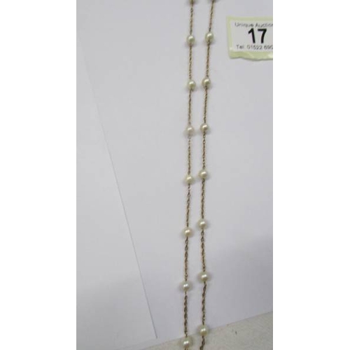 17 - An opera length gold necklace with pearls.
