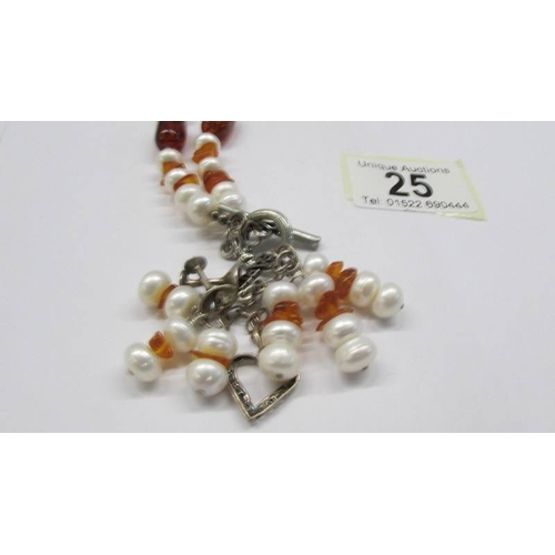 25 - A vintage coloured stone necklace with silver clasp and several silver charms