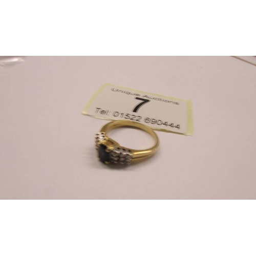 7 - An 18ct gold sapphire ring with diamond shoulders. Size J, 3.5 grams.