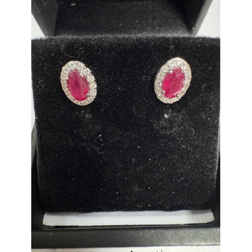 14 - A pair of 18ct ruby & diamond stud earrings